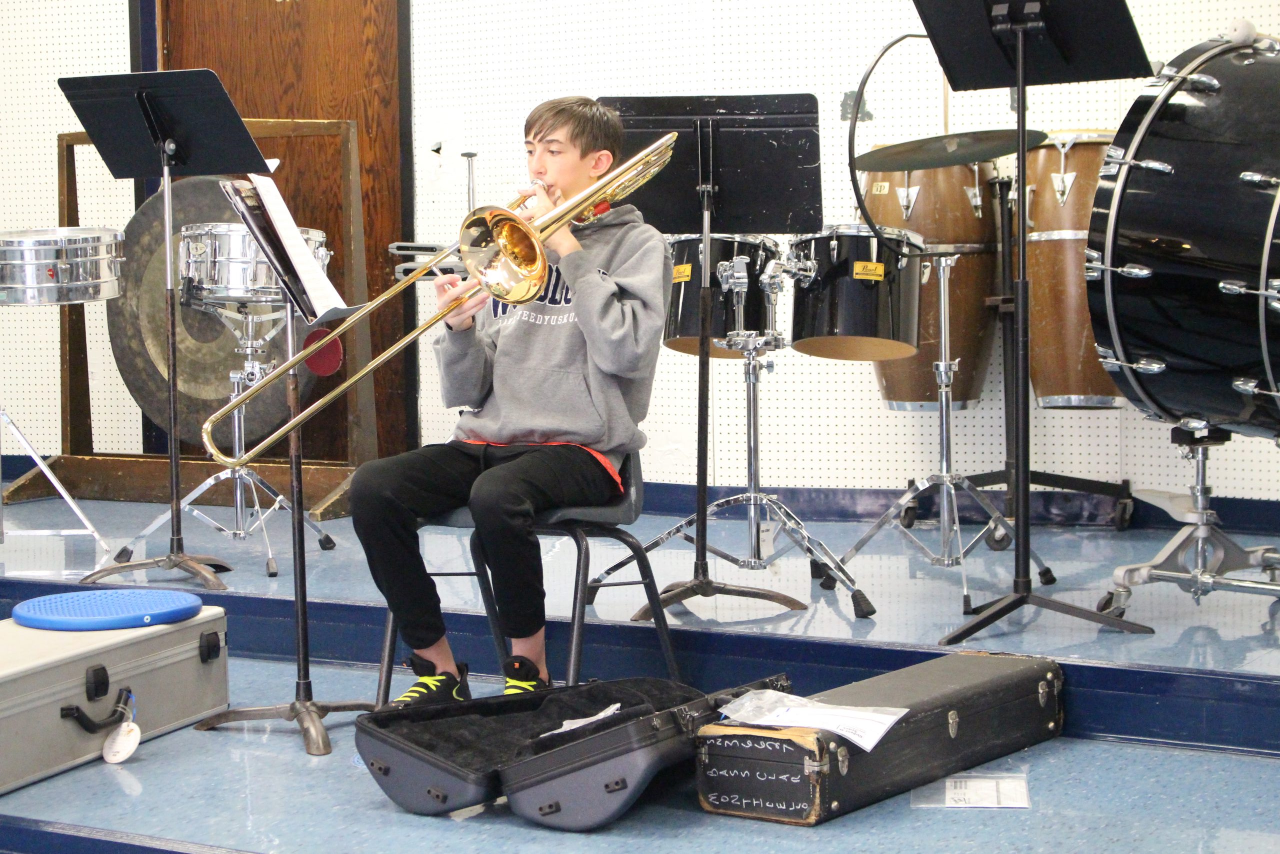 a boy is playing the trombone 