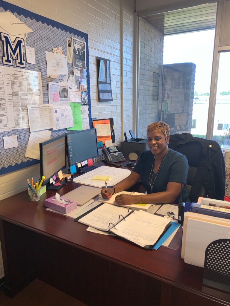 Rachel Blount is sitting at a desk 