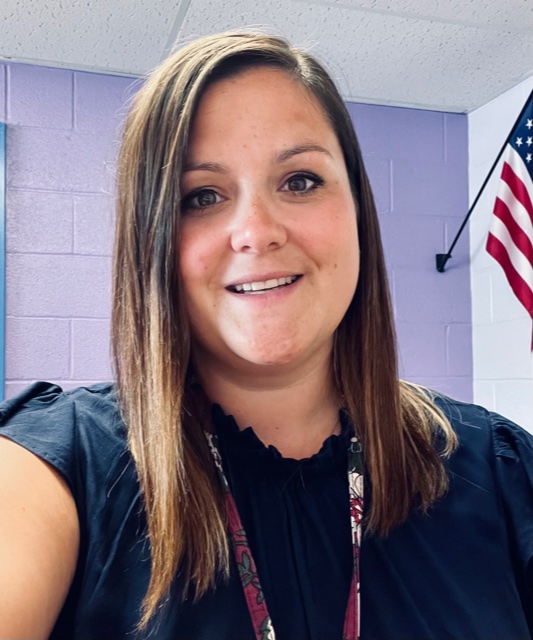 selfie of sarah mootz. She is wearing a blue shirt and has long straight brown hair