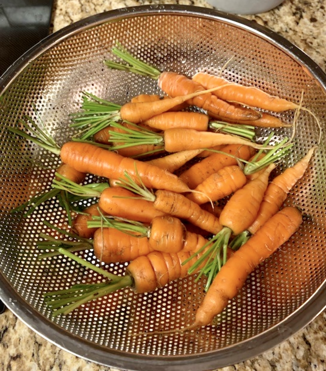 a colandar full of carrots 