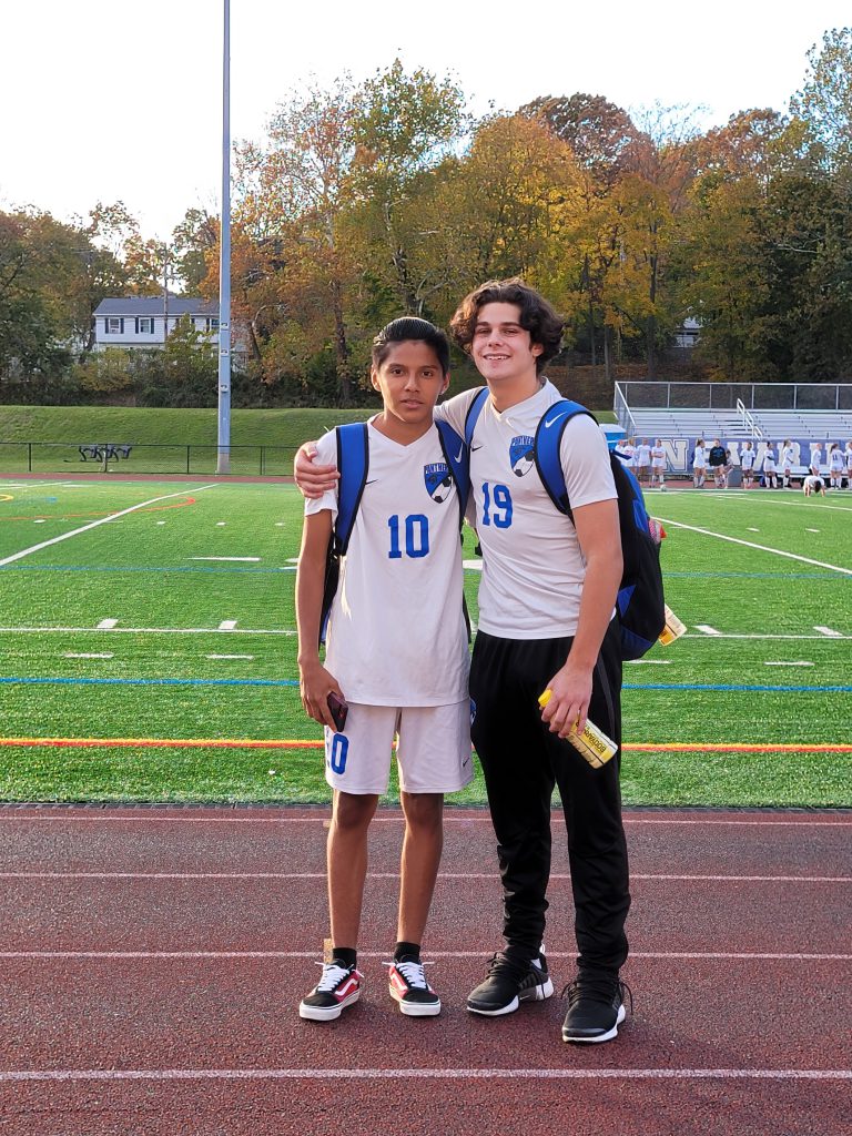 two soccer players are standing in a field