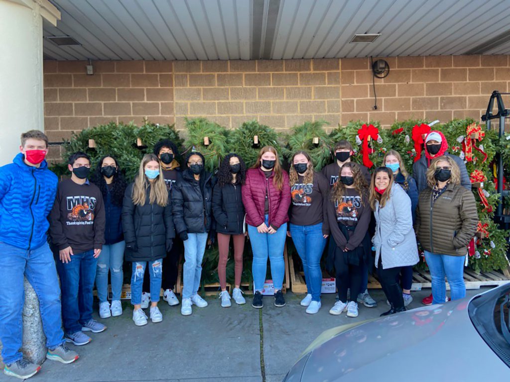 Monticello High School students from the Thanksgiving Food Drive Committee posing for a group picture outside of Shop Rite.