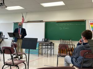 superintendent of schools matt evans is standing in the front of a classroom 