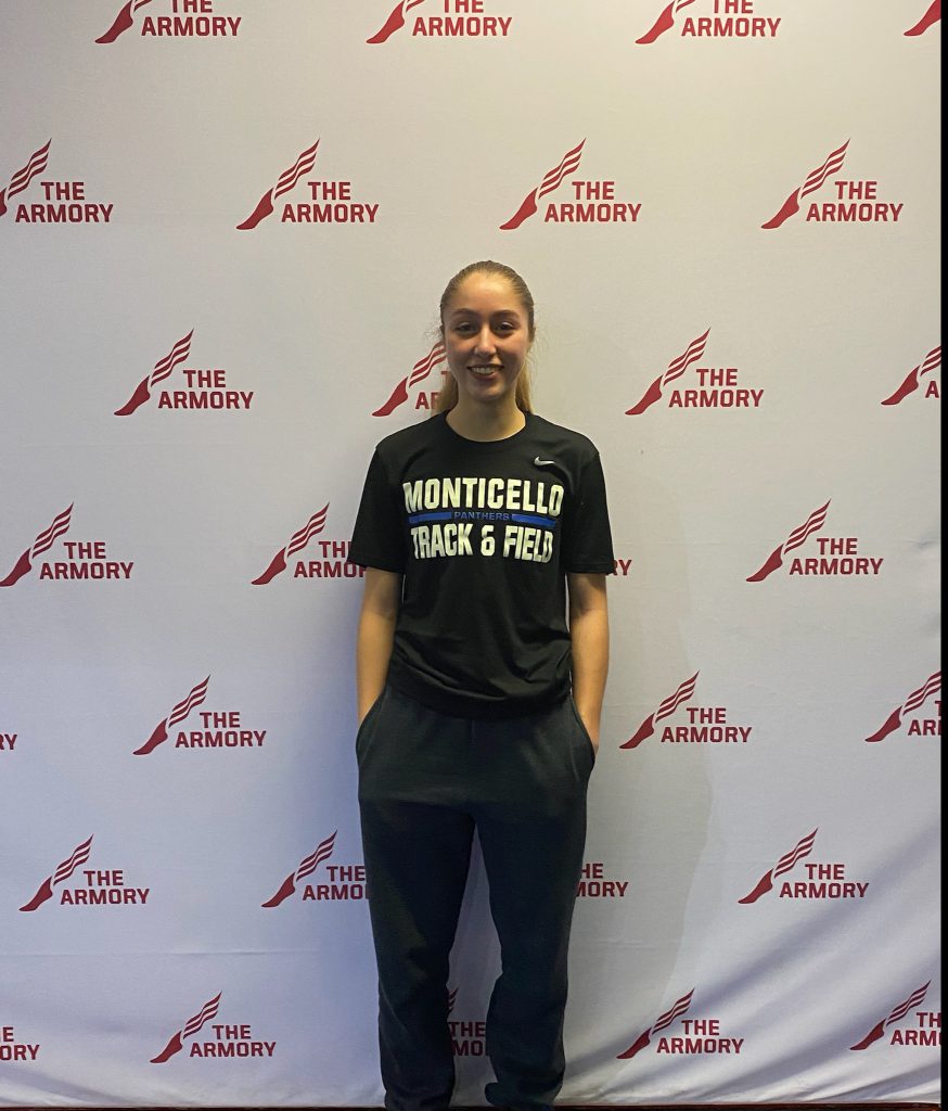 Taina DeJesus is standing in front of a step and repeat banner that reads "Armory" 