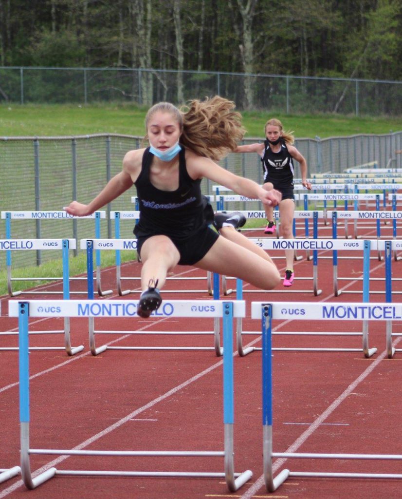 taina dejesus is jumping over a hurdle 