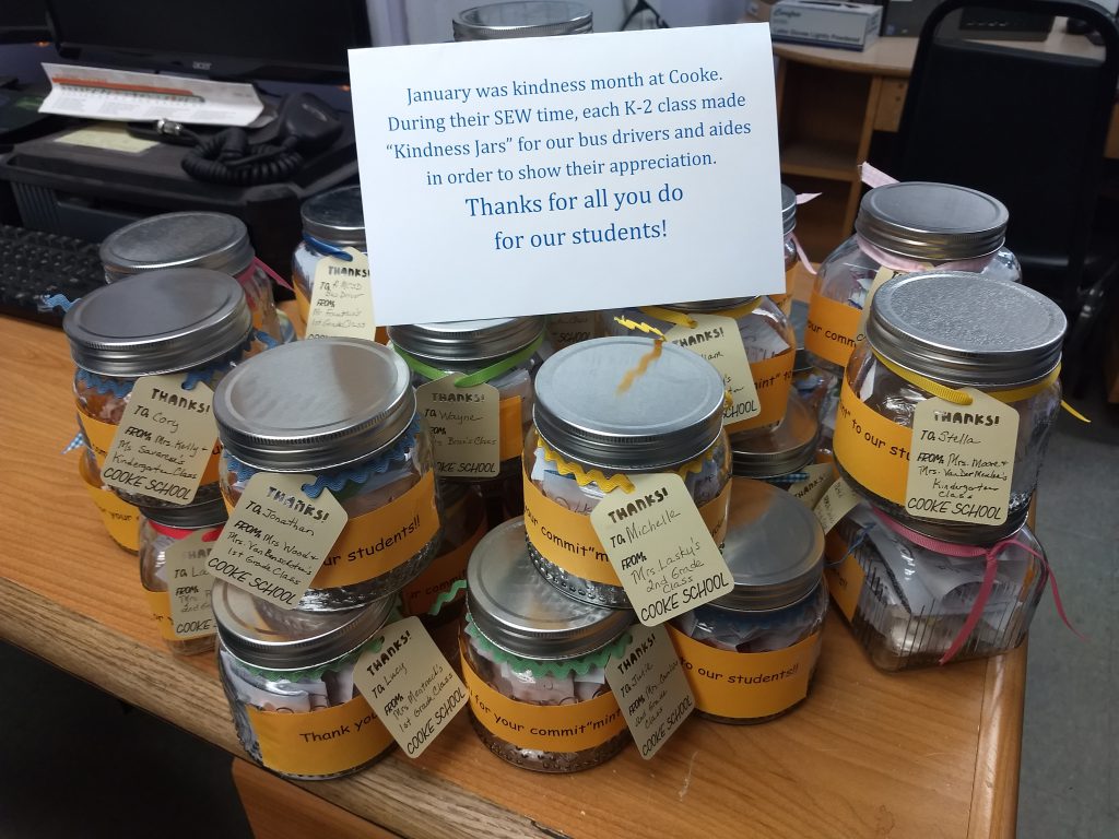 a group of glass jars containing treats are stacked up on a table 