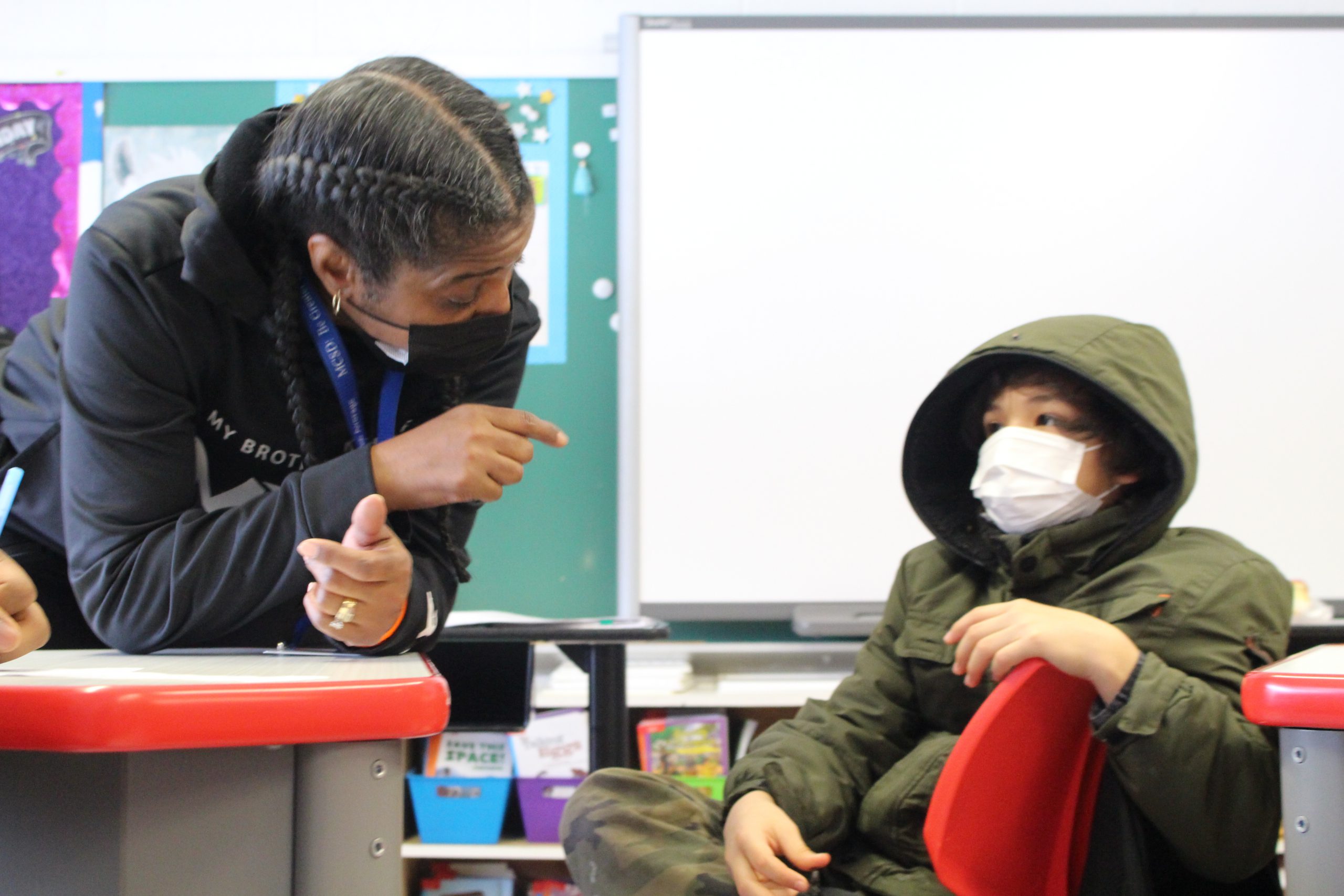 a teacher is speaking to a student 