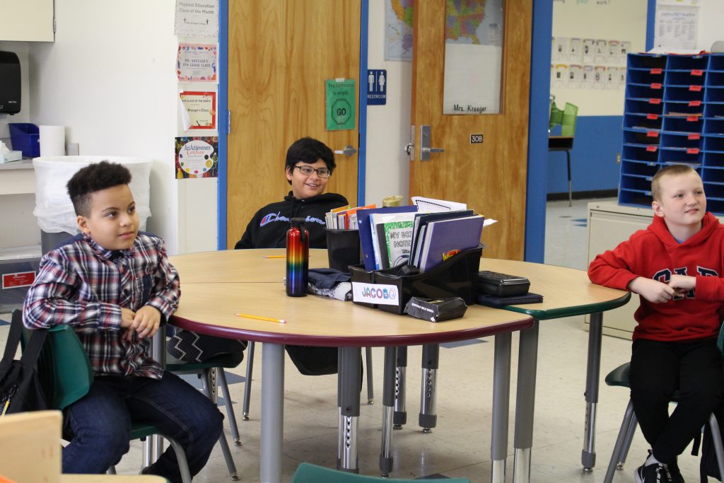 a group of students is listening to a presentation. 