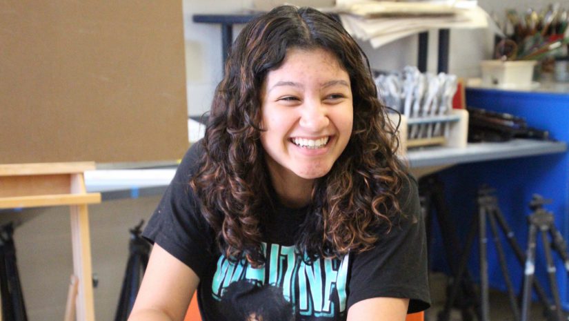 a female student is smiling