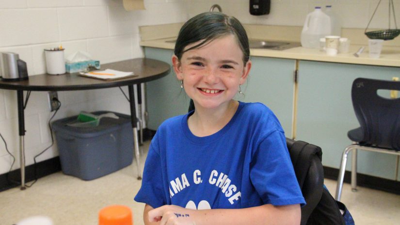 a female student is smiling