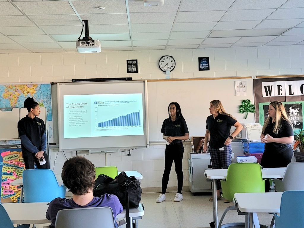 a group of high school aged students are standing in the front of a classroom 