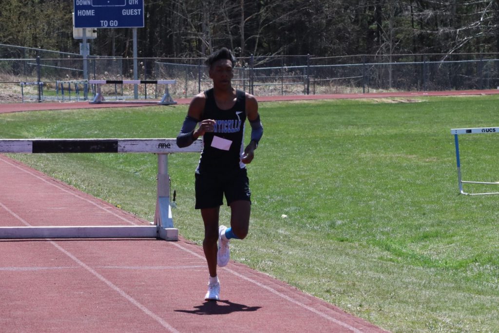 a male track athlete is running on a track 