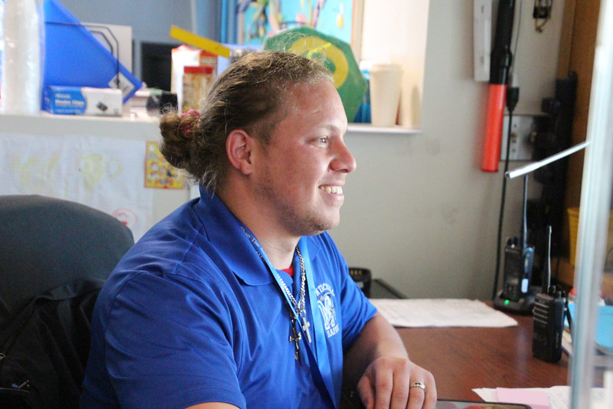 district employee smiling while working at desk