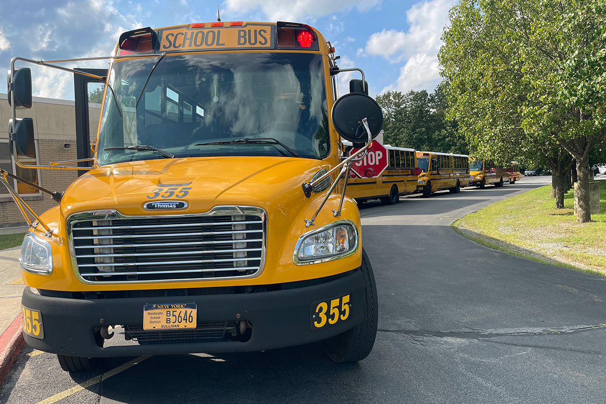 busses in a line outside school waiting for students