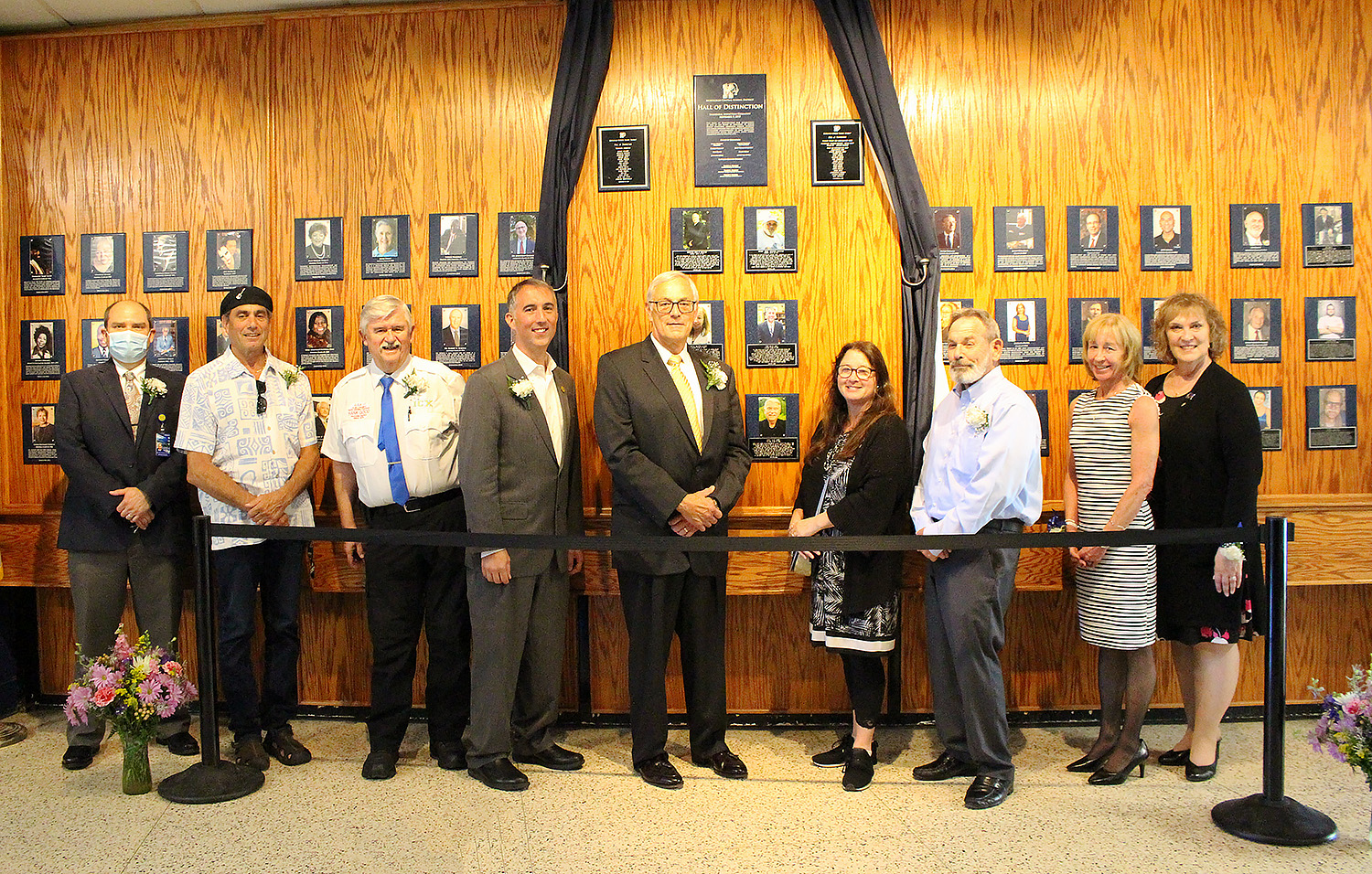 Hall of Distinction honorees, Lori Orestano James and Superintendent Evans standing in front of the Hall of Distinction outside the MHS Auditorium.