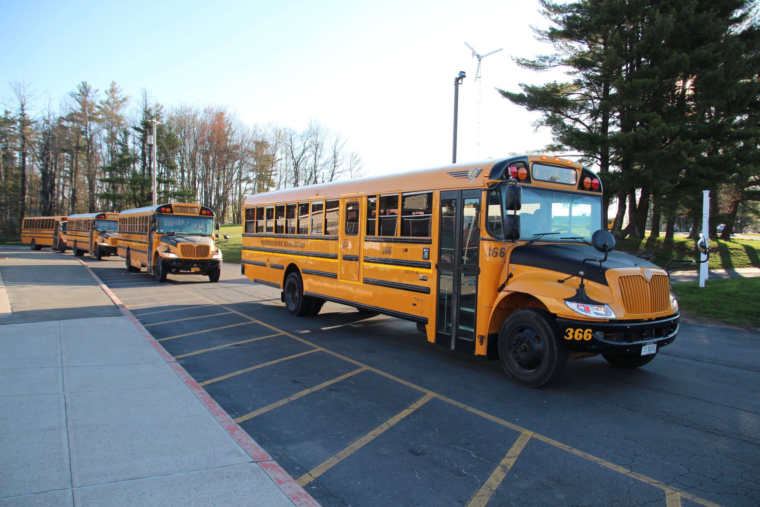 A school bus is parked in the school's parking lot.