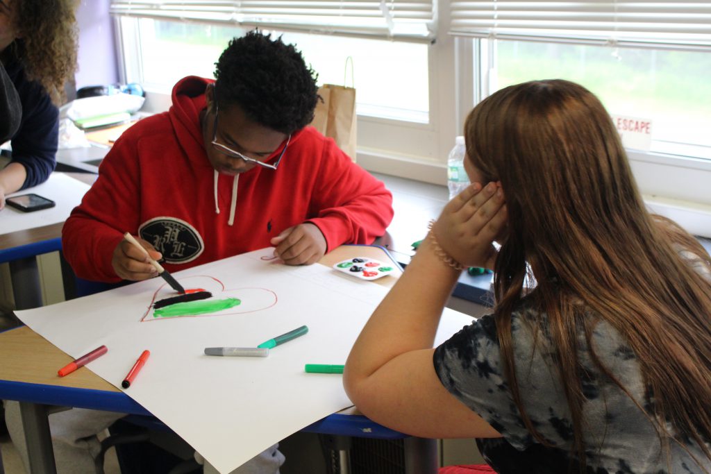 a student is decorating a poster 