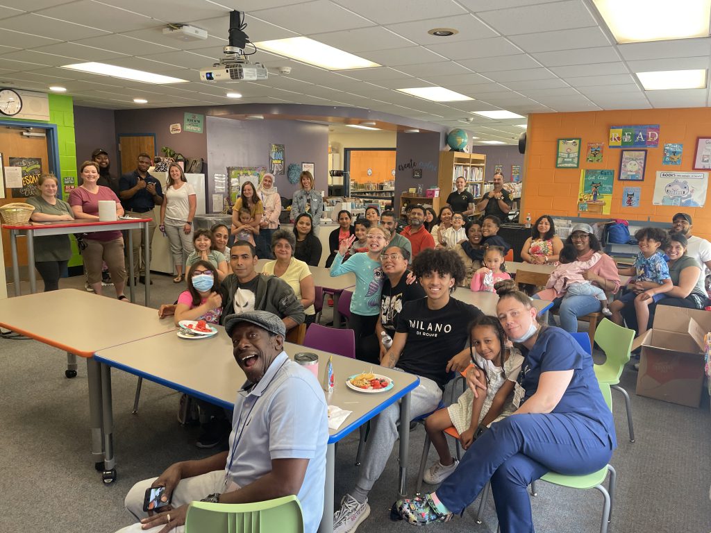 a large group of people are in a library room 