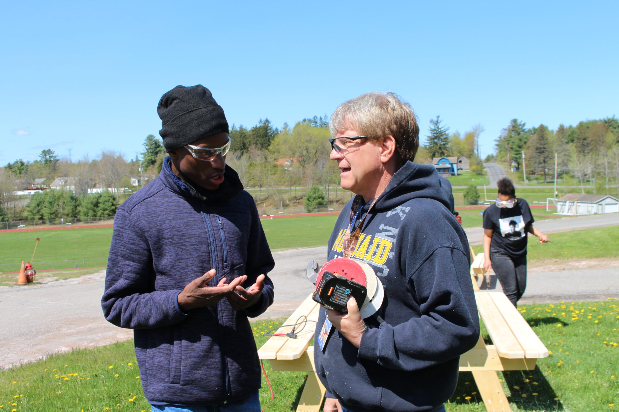 Two Monticello employees are speaking to each other outside the school.