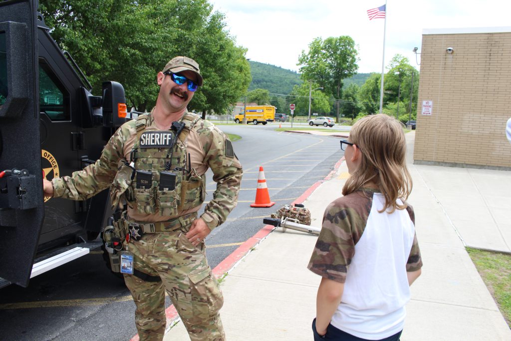 deputy mike barrett talks to a student