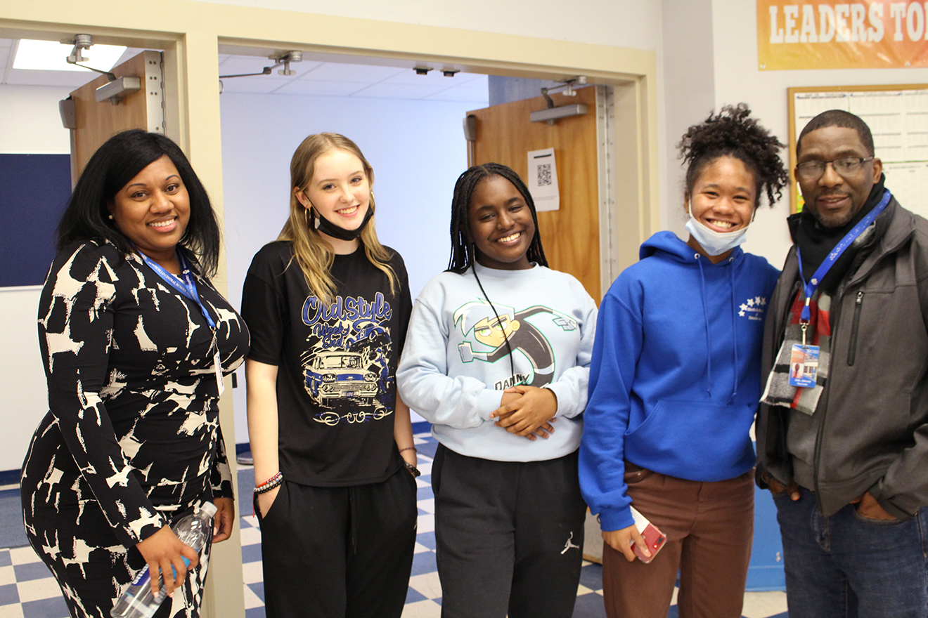 teacher working with group of students