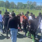 students are gathered in a group outdoors