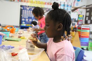 a young girl is eating food