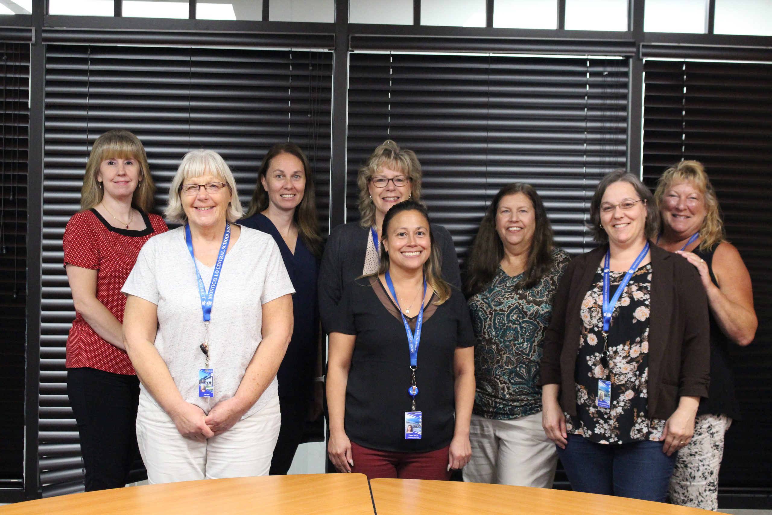 a group of women are posing in a conference room 