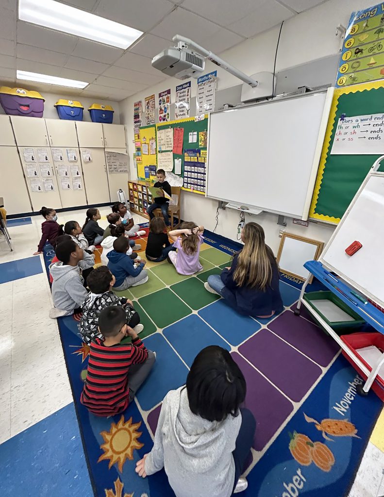 Albi Hajdaraj reading his book to his class. 