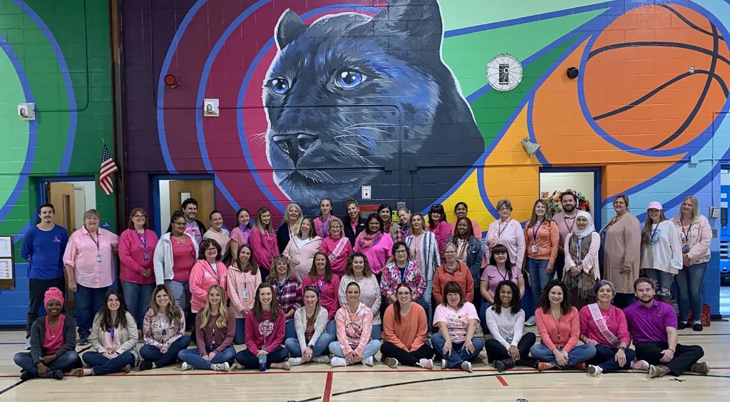 Group photo of Cooke Elementary staff wearing pink and denim.