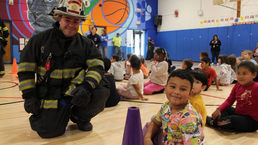 a fireman and a student and posing and smiling