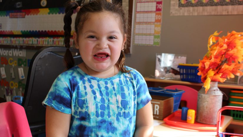 a young girl is smiling