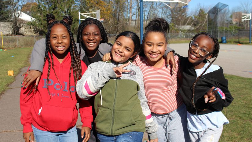 students on a playground are posing