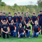 a group of students in trap team uniforms are posing