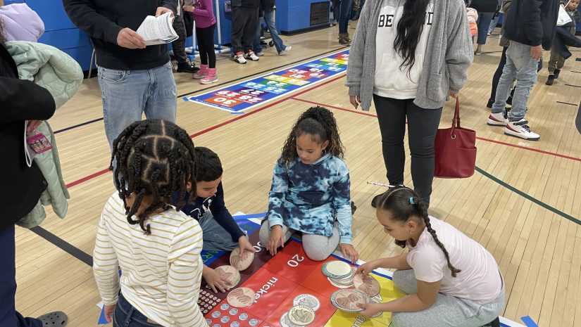 a group of students are on the floor doing a math activity