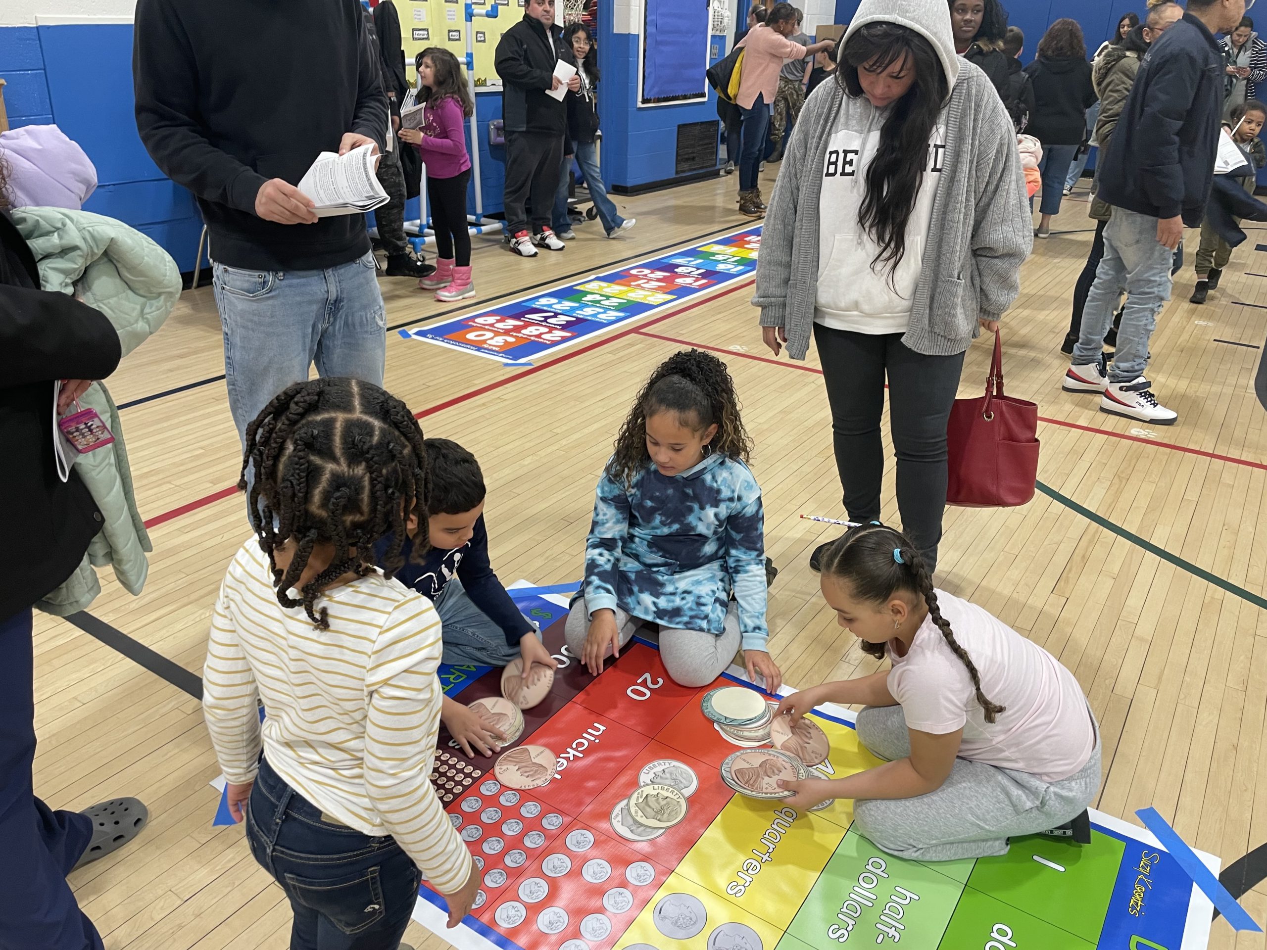 a group of students are on the floor doing a math activity 