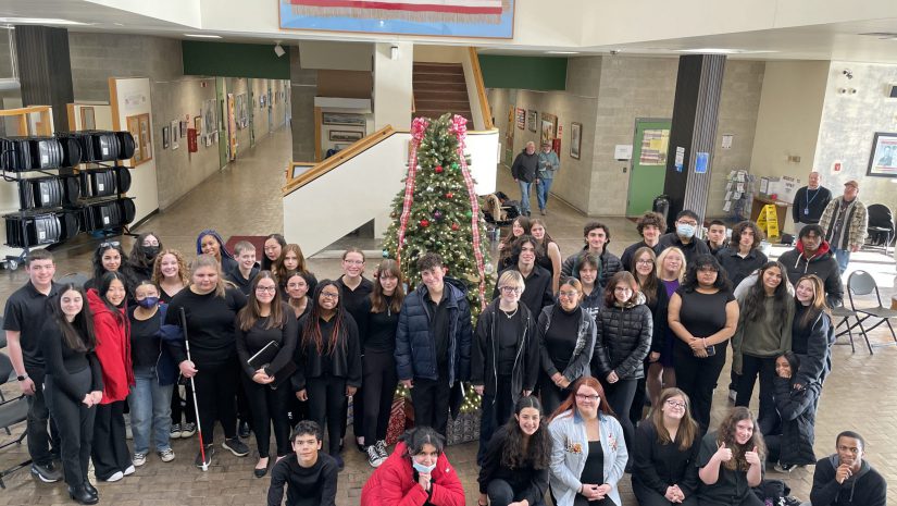 a large group of music students are posing.