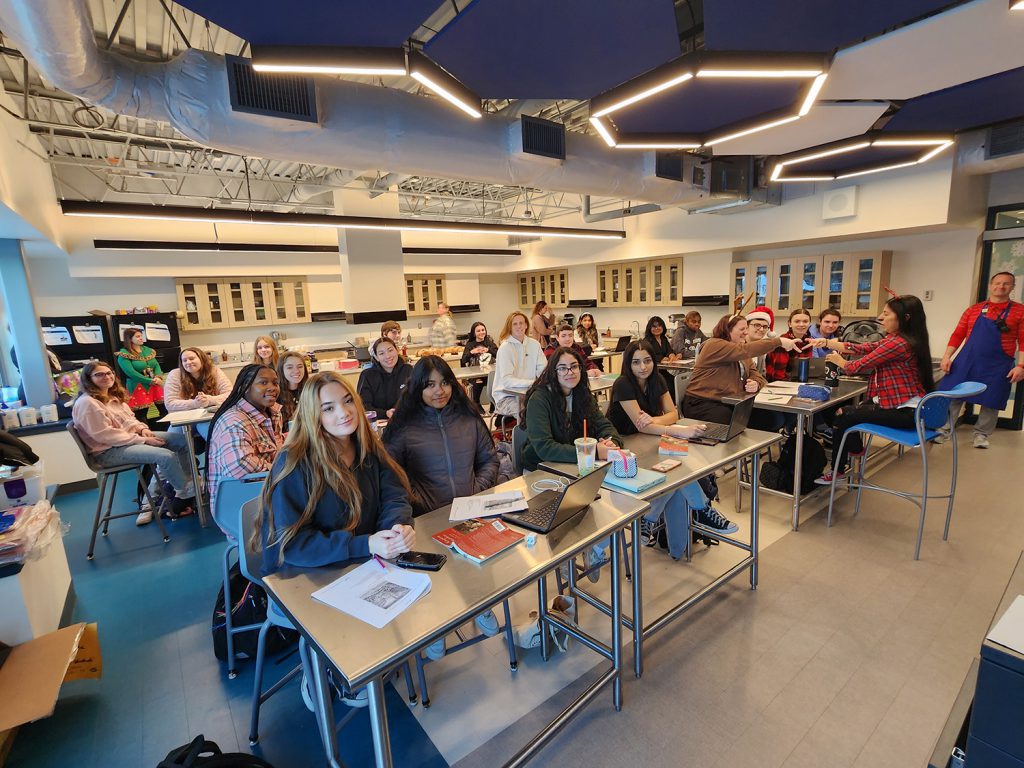 Students sitting at desks in classroom.