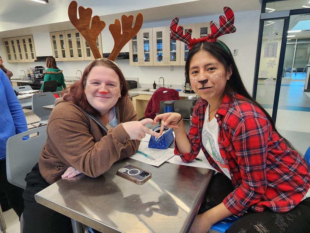 Two students dressed as reindeer.