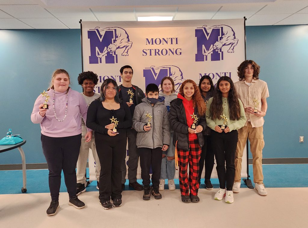 High school students holding their awards for a group photo.