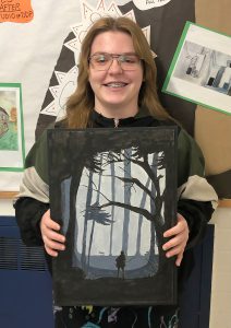 Student holding her artwork.