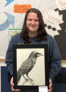 Student holding her artwork.