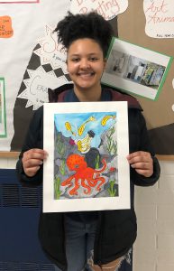 Student holding her artwork.