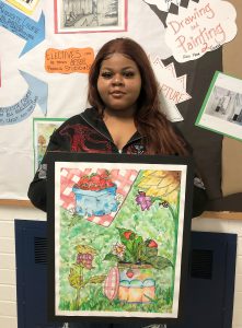 Student holding her artwork.