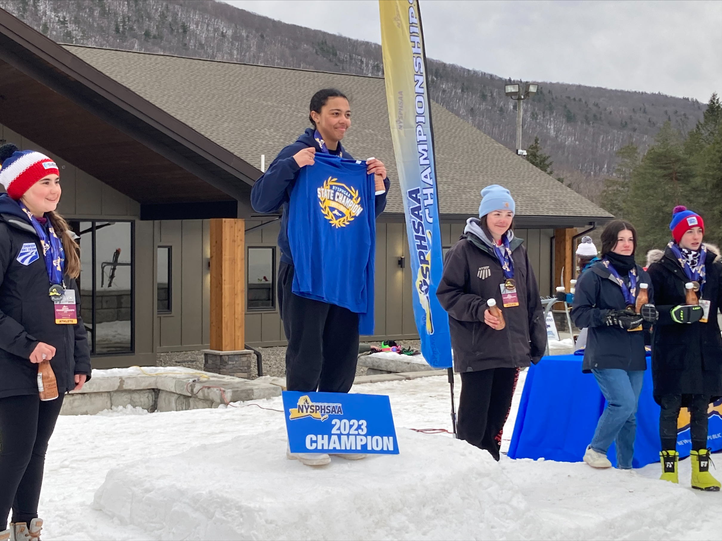 Alexis Heins is standing with a medal