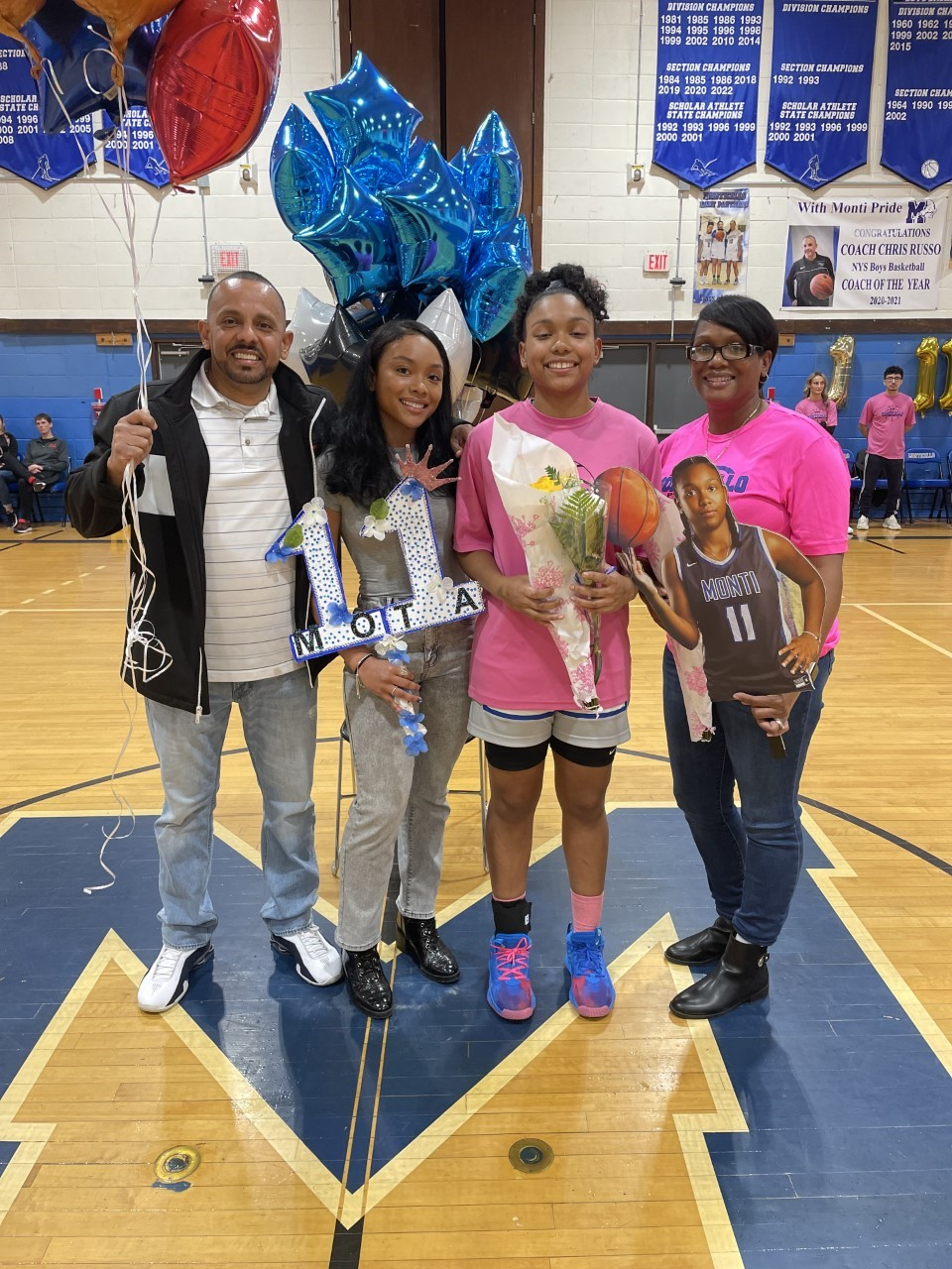 senior athletes pose with their family