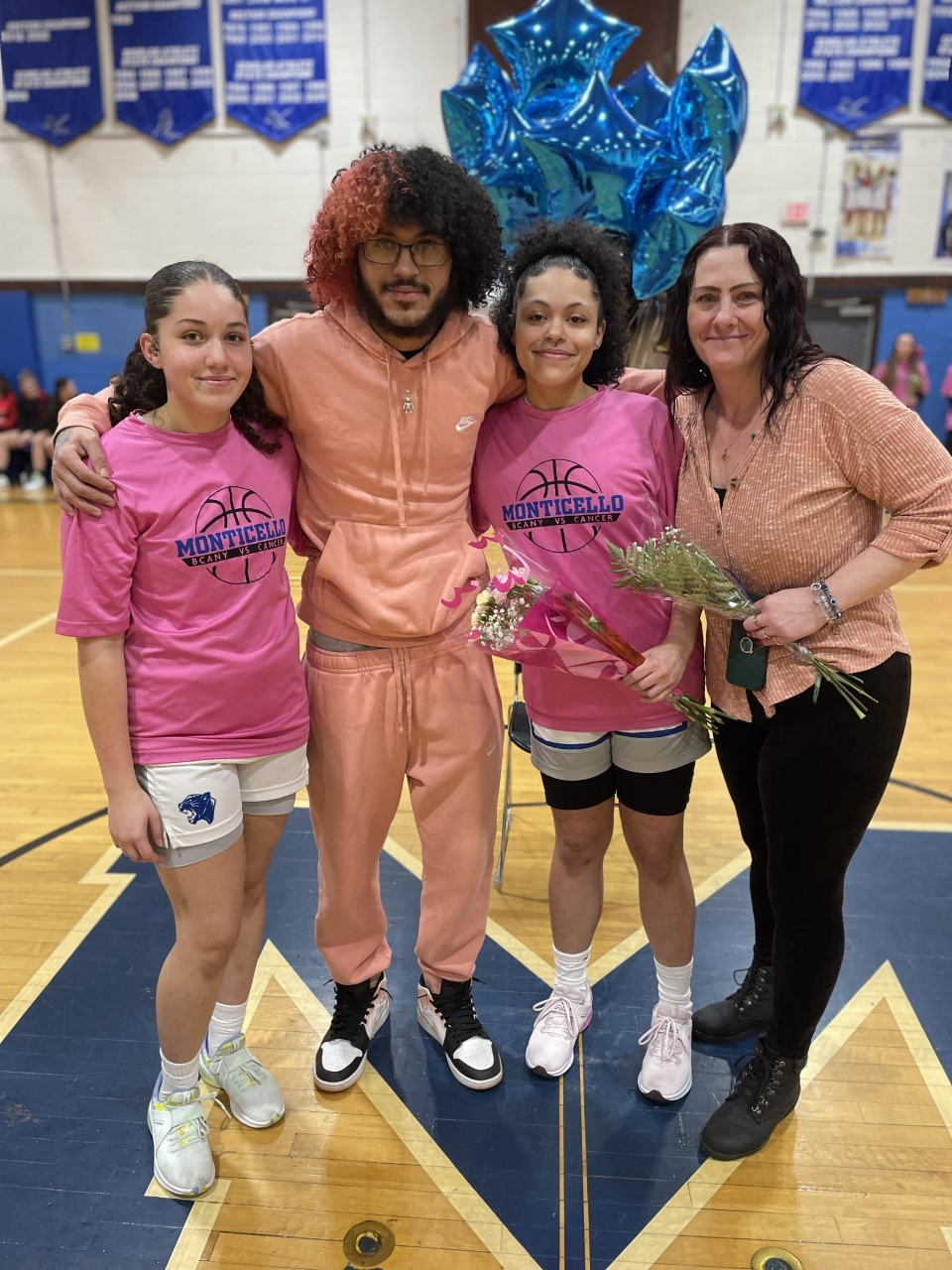 senior athletes pose with their family