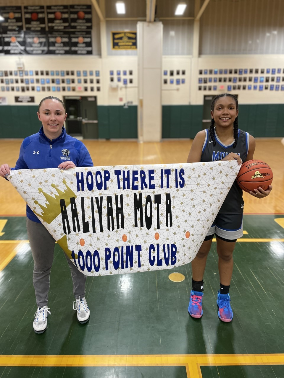 Aaliyah Mota poses with a banner displaying her name 