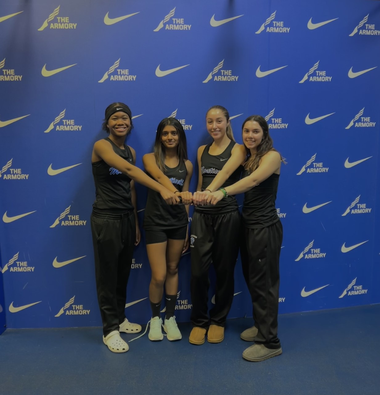 a group of female athletes are posing