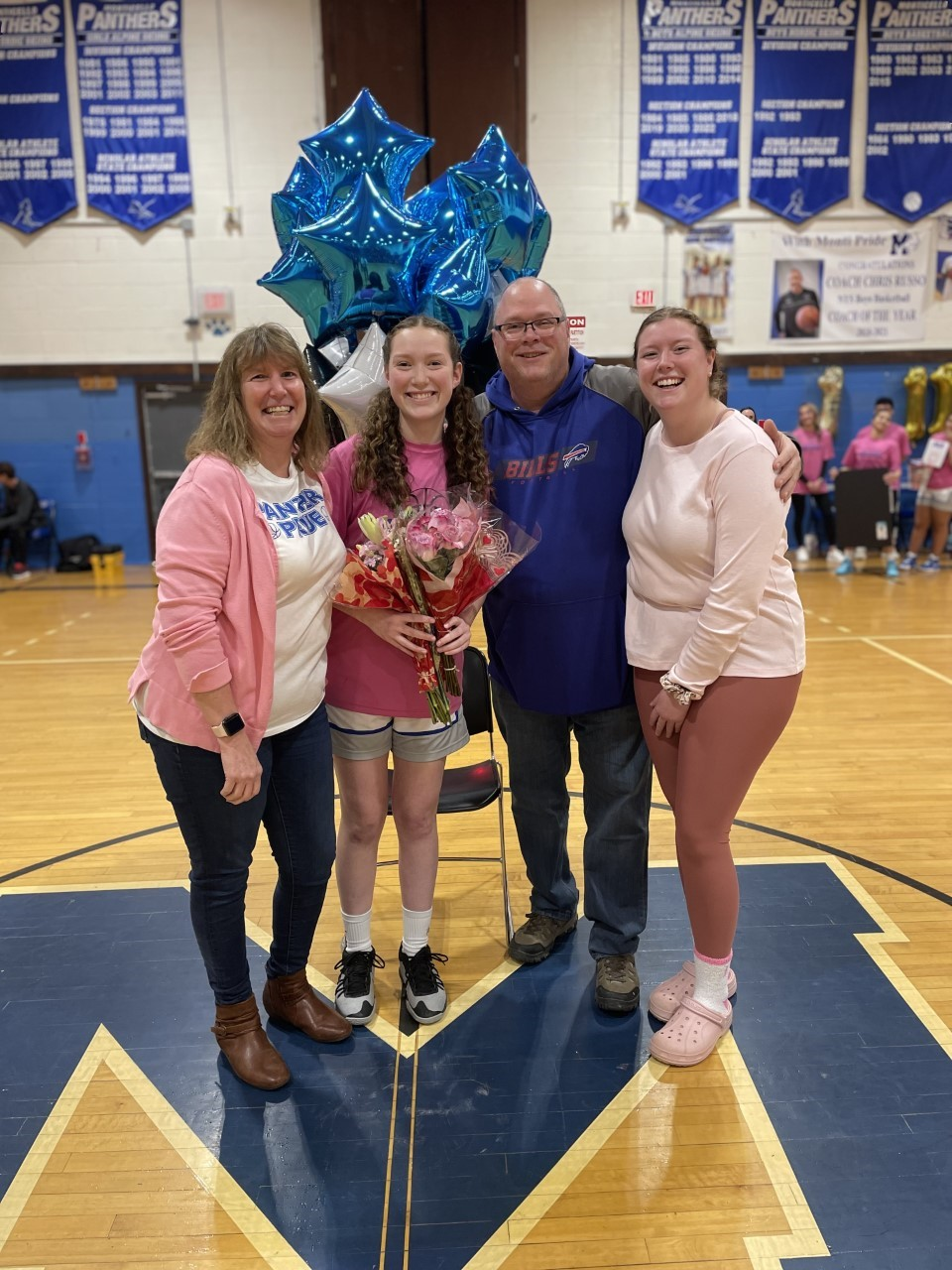 senior athletes pose with their family